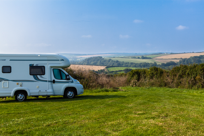 Motorhome on a grassy touring pitch overlooking fields at Ponderosa